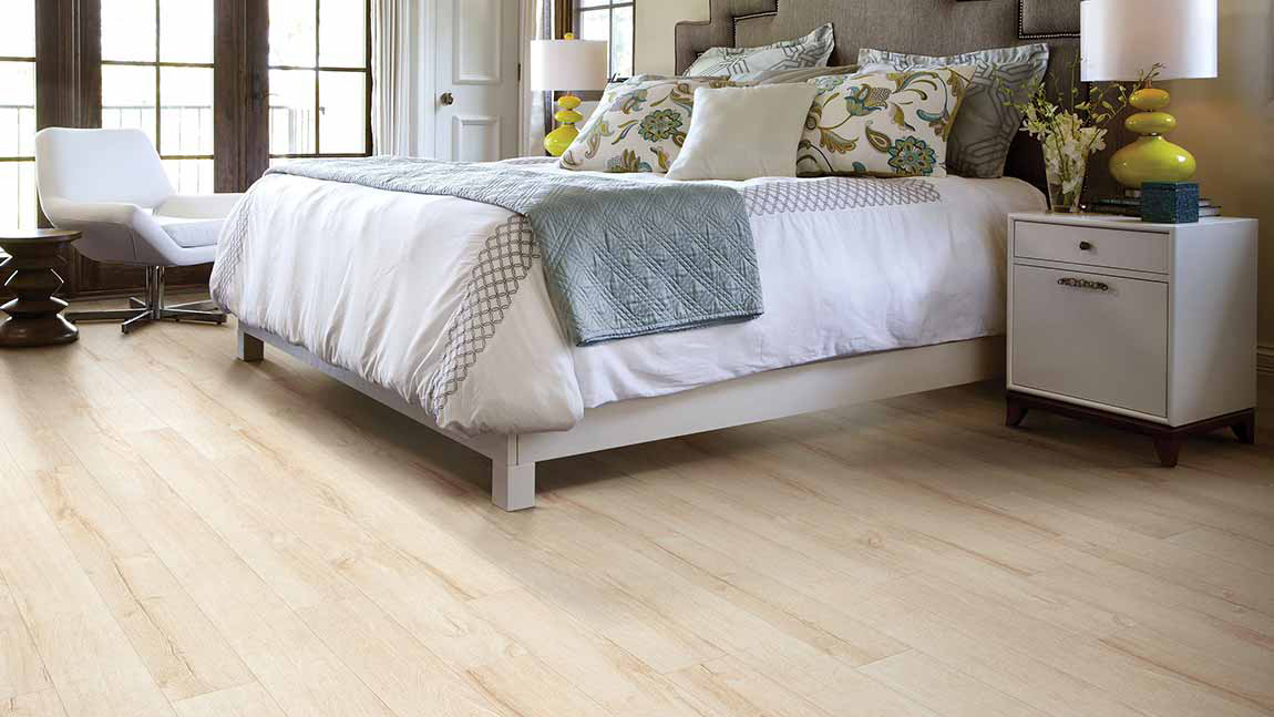 Laminate by Shaw Floors in bedroom with a wood-look theme.